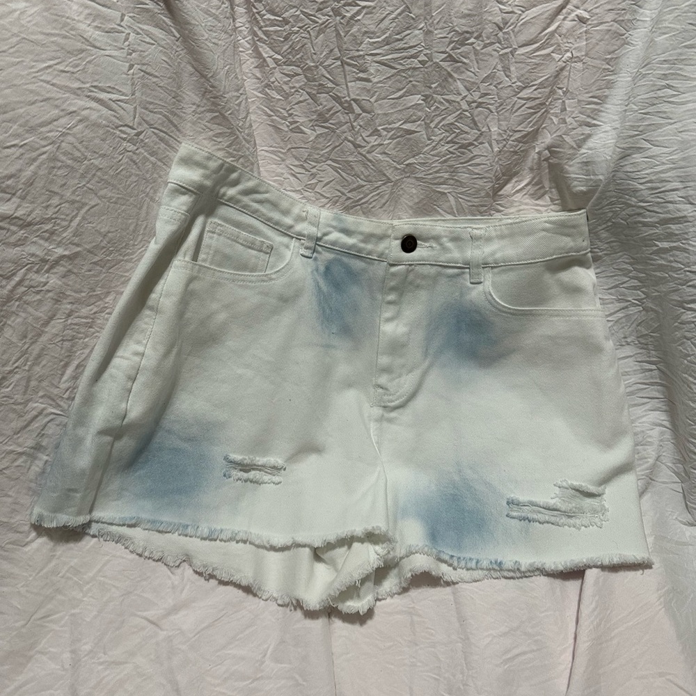 White shorts with blue tie dye shorts.